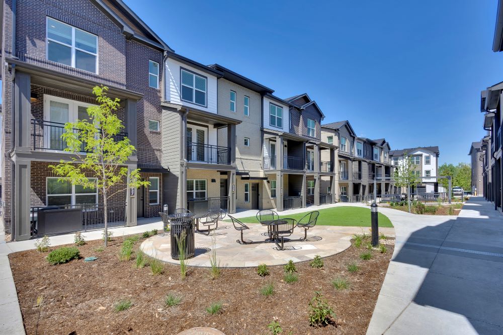 View from outdoor courtyard with townhomes in background